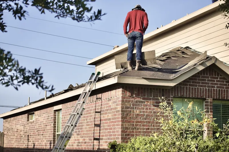 Professional roofer working on a residential roof in Phalanx